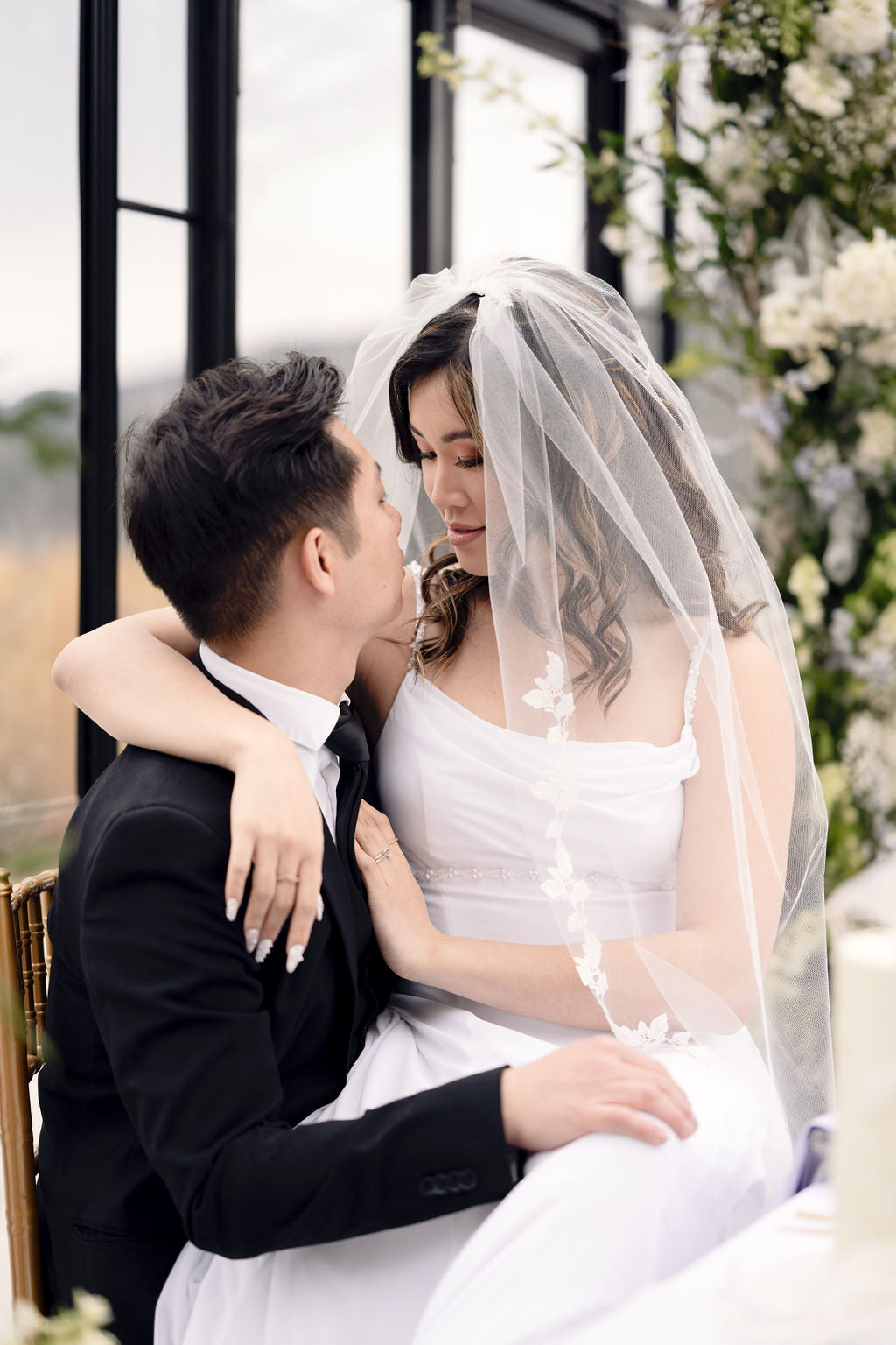 Romantic fingertip length wedding veil with delicate lace appliqué edge, worn by bride in modern minimalist wedding dress, Kelowna wedding, Okanagan bridal accessories