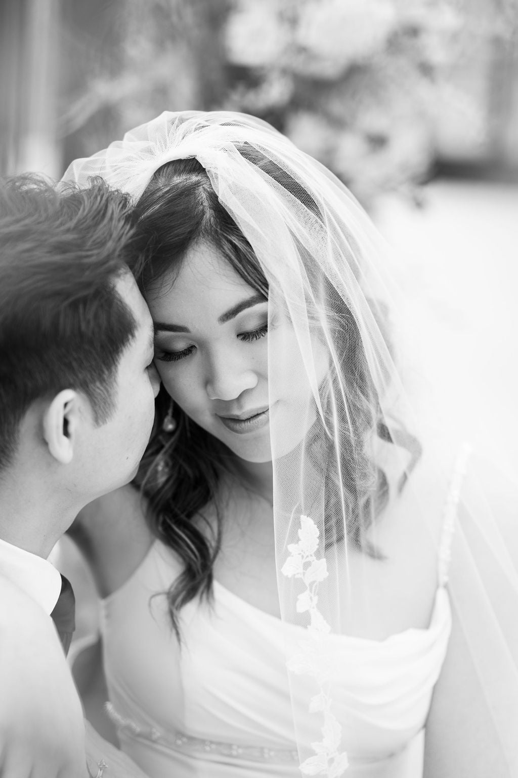 Black and white romantic portrait of bride wearing EVERLY lace edge veil, intimate wedding moment, timeless bridal photography, handcrafted BC wedding veil